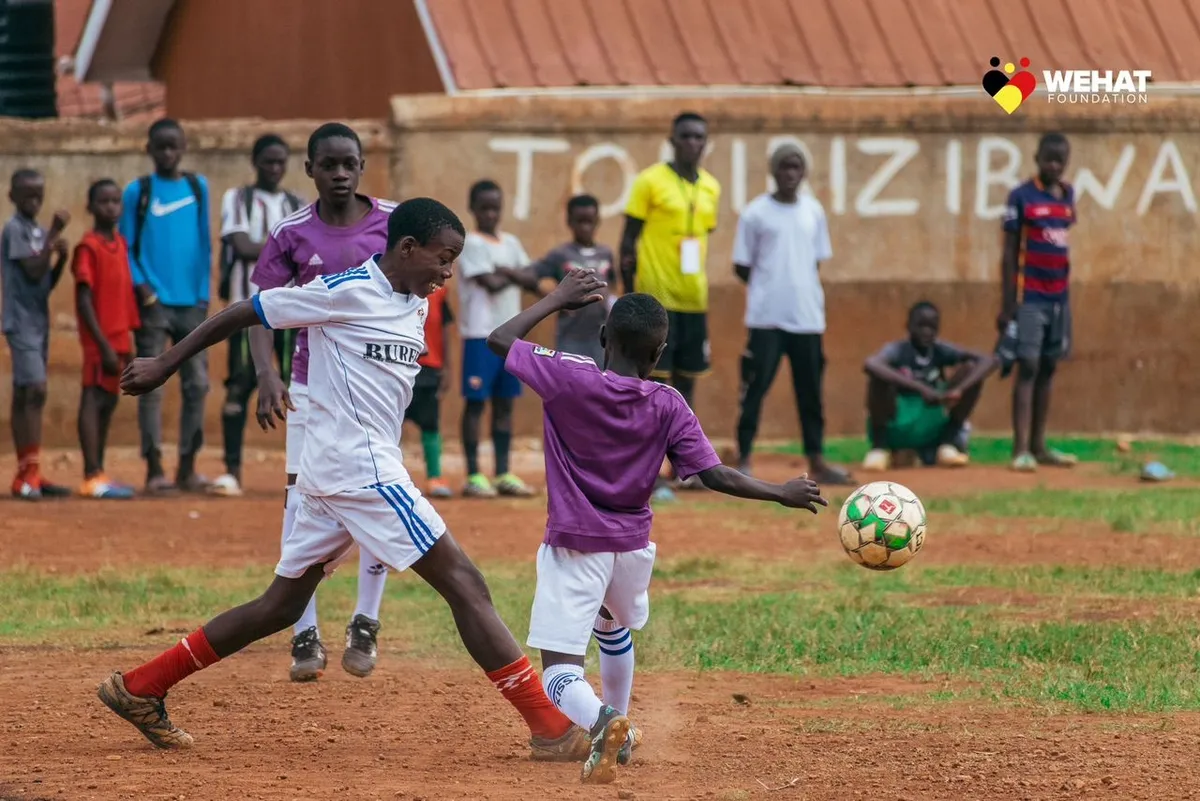 Children playing football during WEHAT Foundation Uganda NGO talent development outreach